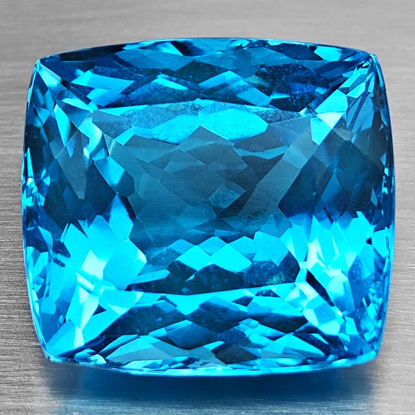 Natural Swiss Blue Topaz Gemstone 53.91 Ct. VVS Cushion Shape 22 x 20 Mm.: Product ID: 807168687 Product Name: Natural Blue Topaz Weight: 53.91 CT. Size: 22 x 20 x 13.8 MM. Shape: Cushion Shape Color: Swiss Blue Clarity:VVS Luster: Good Gems Origin: Brazil Treatment: Treated