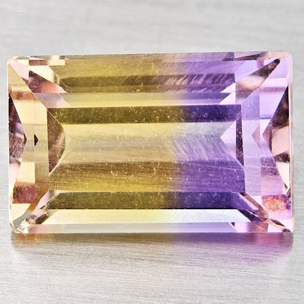 Natural Bi Color Ametrine Gemstones 3.17 Ct. Baguette Shape 11 x 7 Mm.: Product ID: 800408498 Product Name: Natural Ametrine Weight: 3.17 CT. Size: 11 x 7 x 5.5 MM. Shape: Baguette Color: Bi Color Clarity:VSI Luster: Good Gems Origin: Bolivia Treatment: Unheated Crystal S