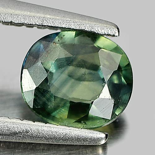 Natural Bluish Green Sapphire Gemstones 0.63 Ct. Oval Shape 5.7 x 5 Mm.: Product ID: 806154673 Product Name: Natural Green Sapphire Weight: 0.63 CT. Size: 5.7 x 5 x 2.3 MM. Shape: Oval Color: Bluish Green Clarity:VSI Luster: Good Gems Origin: Thailand Treatment: Heated Cry