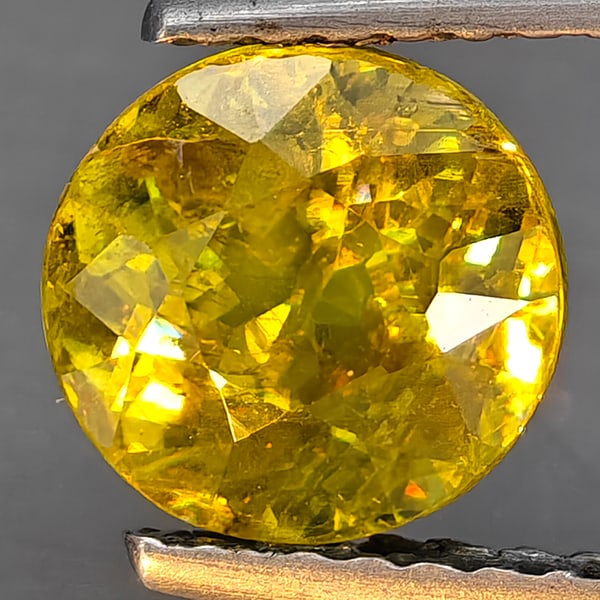 Natural Multi-Color Sphene With Rainbow Spark 1.71 Ct. Round Shape 7.1 Mm.: Product ID: 806509096 Product Name: Natural Sphene Weight: 1.71 CT. Size: 7.1 x 7.1 x 4.9 MM. Shape: Round Shape Color: Multi-Color Clarity:SI1 Luster: Good Gems Origin: Madagascar Treatment: Unheated