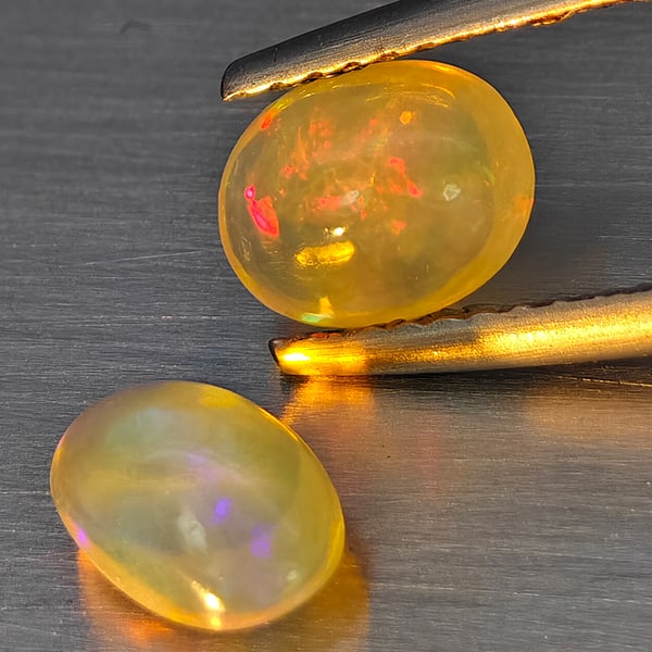 Natural Multi Color Play Of Colour Opal Gemstones 1.12 Ct. 2 Pcs. Oval Cabochon Shape 7.5 x 5 Mm.: Product ID: 818728365 Product Name: Natural Opal Weight: 1.12 CT. Size: 7.5 x 5 x 3.7 MM. Shape: Oval Cabochon Color: Multi-Color Clarity:None Luster: Good Gems Origin: Ethiopia Treatment: Unheated Cr