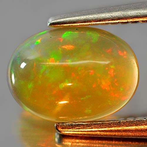 Natural Multi Color Play Of Colour Opal Gemstones 0.62 Ct. Oval Cabochon Shape 8.1 x 5.9 Mm.: Product ID: 818726304 Product Name: Natural Opal Weight: 0.62 CT. Size: 8.1 x 5.9 x 3 MM. Shape: Oval Cabochon Color: Multi Color Clarity:Semi - Transparent Luster: Iridescent Gems Origin: Ethiopia Tr