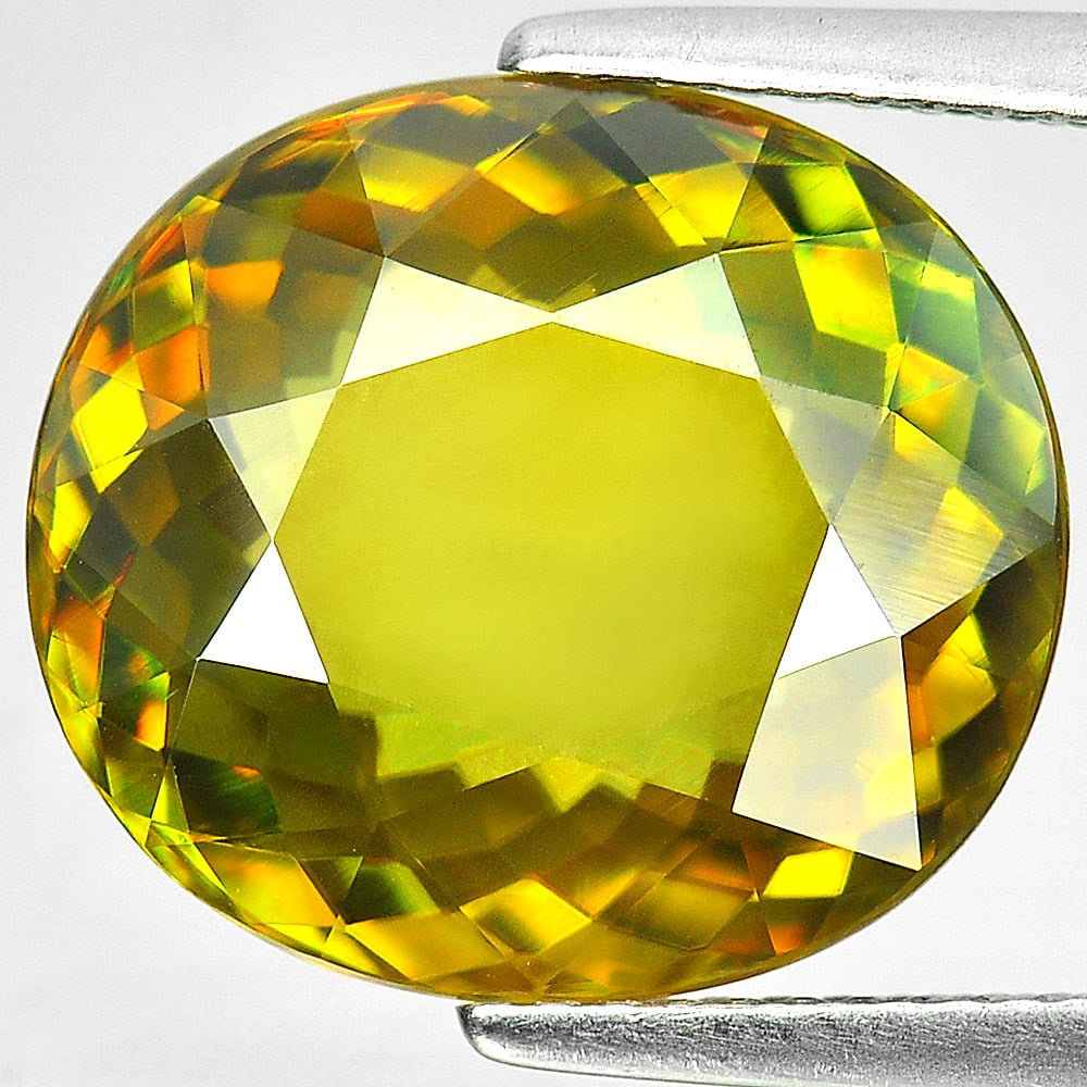 Natural Multi Color Titanium Sphene Gemstones Rainbow Spark 8.35 Ct. Oval Shape 14.4 x 12.9 Mm.: Product ID: 806507454 Product Name: Natural Sphene Weight: 8.35 CT. Size: 14.4 x 12.9 x 5.6 MM. Shape: Oval Color: Multi Color With Rainbow Spark Clarity:VVS Luster: Adamantine Gems Origin: Madagascar