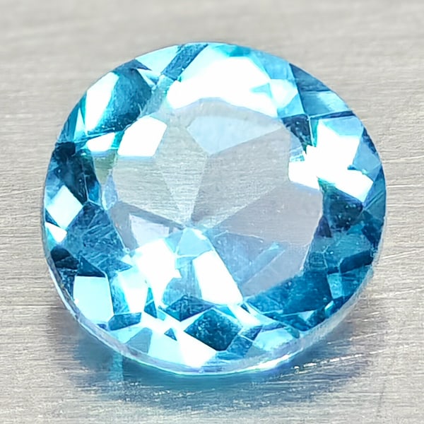 Natural Swiss Blue Topaz Gemstones 0.60 Ct. Round Shape 5.2 Mm.: Product ID: 807168120 Product Name: Natural Blue Topaz Weight: 0.60 CT. Size: 5.2 x 5.2 x 3 MM. Shape: Round Shape Color: Swiss Blue Clarity:VSI Luster: Good Gems Origin: Brazil Treatment: Treated Cry