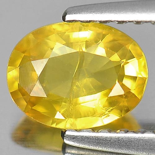 Natural Yellow Sapphire Gemstones 0.89 Ct. Oval Shape 6.8 x 5 Mm.: Product ID: 806157654 Product Name: Natural Yellow Sapphire Weight: 0.89 CT. Size: 6.8 x 5 x 3 MM. Shape: Oval Color: Yellow Clarity:SI1 Luster: Good Gems Origin: Thailand Treatment: Heated Crystal St