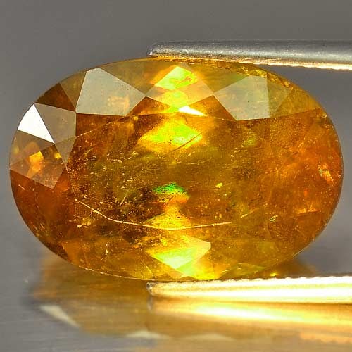 Natural Green Titanium Sphene Red Spark 15.89 Ct. Oval 19.7 x 13.4 Mm.: Product ID: 806500578 Product Name: Natural Sphene Weight: 15.89 CT. Size: 19.7 x 13.4 x 7.9 MM. Shape: Oval Color: Intense Green With Red Spark Clarity:SI Luster: Adamantine Gems Origin: Madagascar T