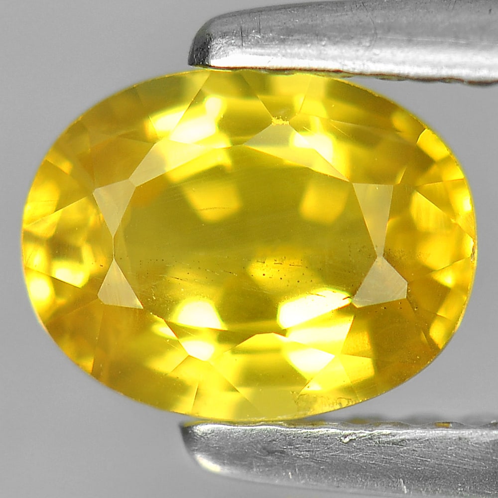Natural Yellow Sapphire Gemstones 1.15 Ct. Oval Shape 6.8 x 5.3 Mm.: Product ID: 806150947 Product Name: Natural Yellow Sapphire Weight: 1.15 CT. Size: 6.8 x 5.3 x 3.5 MM. Shape: Oval Color: Yellow Clarity:VSI Luster: Very Good Gems Origin: Thailand Treatment: Heated C