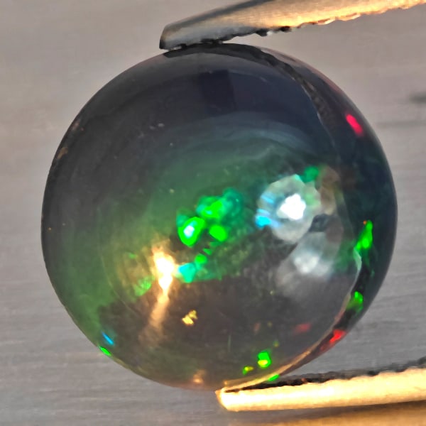 Natural Multi Color Opal Gemstones 3.31 Ct. Round Cabochon Shape 11.8 Mm.: Product ID: 818728584 Product Name: Natural Opal Weight: 3.31 CT. Size: 11.8 x 11.8 x 5.8 MM. Shape: Round Cabochon Color: Multi-Color Clarity:Semi - Transparent Luster: Good Gems Origin: Ethiopia Tre