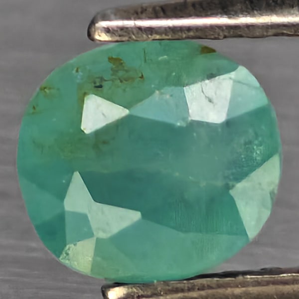 Natural Green Blueish Grandidierite Gemstones1.25 Ct. Oval Shape 6 x 4.9 Mm.: Product ID: 803100101 Product Name: Natural Tsavorite Weight: 1.25 CT. Size: 6 x 4.9 x 4.6 MM. Shape: Oval Shape Color: Green Blueish Clarity:SI1 Luster: Good Gems Origin: Madagascar Treatment: Unheat