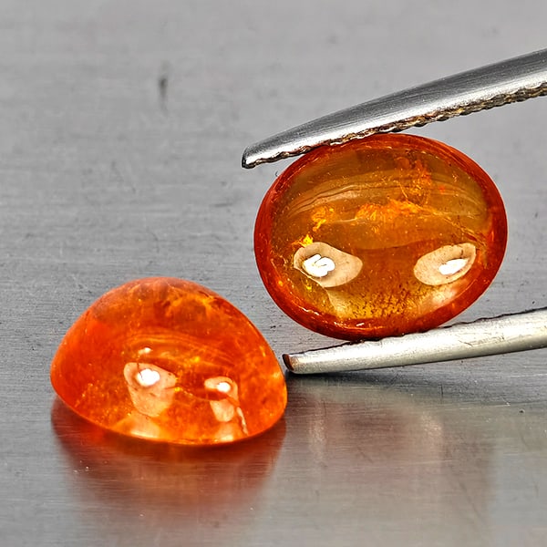 Natural Orangish Red Spessartine Garnet Gemstones 5.33 Ct. 2 Pcs. Oval Cabochon Shape 9 x 7.3 Mm.: Product ID: 802937986 Product Name: Natural Garnet Weight: 5.33 CT. Size: 9 x 7.3 x 4.7 MM. Shape: Oval Cabochon Color: Orangish Red Clarity:SI1 Luster: Good Gems Origin: Namibia Treatment: Unheated C