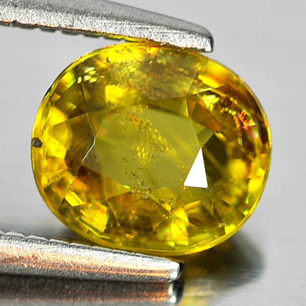 Natural Multi Color Sphene Gemstones With Rainbow Spark 1.07 Ct. Oval Shape 6.6 x 5.8 Mm.: Product ID: 806507641 Product Name: Natural Sphene Weight: 1.07 CT. Size: 6.6 x 5.8 x 3.3 MM. Shape: Oval Color: Multi-Color Clarity:SI1 Luster: Adamantine Gems Origin: Madagascar Treatment: Unheated 