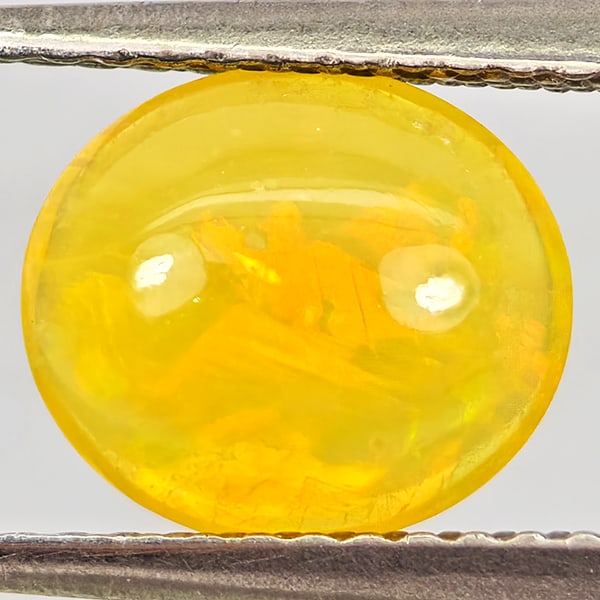 Natural Multi-Color Play Of Colour Opal Gemstones 0.90 Ct. Oval Cabochon Shape 8.7 x 7.6 Mm.: Product ID: 818728053 Product Name: Natural Opal Weight: 0.90 CT. Size: 8.7 x 7.6 x 3.5 MM. Shape: Oval Cabochon Color: Multi-Color Clarity:Semi - Transparent Luster: Good Gems Origin: Ethiopia Treatm