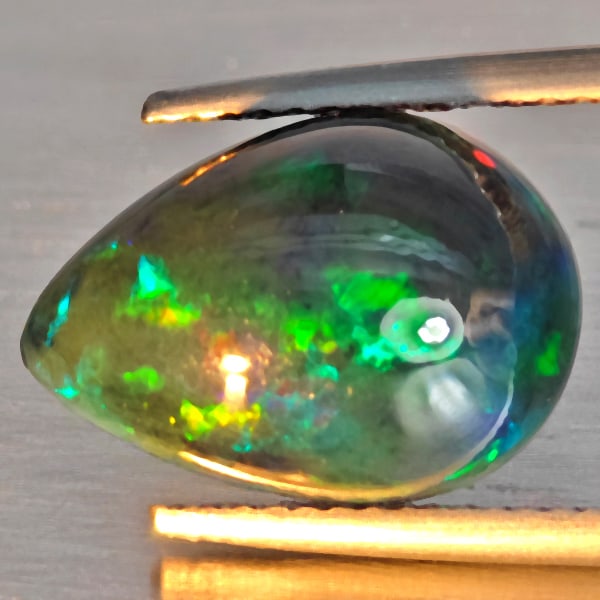 Natural Multi Color Play Of Colour Opal Gemstones 3.25 Ct. Pear Cabochon Shape 14.3 x 10 Mm.: Product ID: 818728529 Product Name: Natural Opal Weight: 3.25 CT. Size: 14.3 x 10 x 6 MM. Shape: Oval Cabochon Color: Multi-Color Clarity:Semi - Transparent Luster: Good Gems Origin: Ethiopia Treatmen