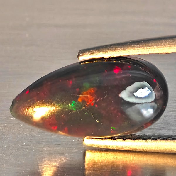 Natural Multi Color Play Of Colour Opal Gemstones 1.44 Ct. Pear Cabochon Shape 13.8 x 7.1 Mm.: Product ID: 818728568 Product Name: Natural Opal Weight: 1.44 CT. Size: 13.8 x 7.1 x 3.5 MM. Shape: Pear Cabochon Shape Color: Multi-Color Clarity:Semi - Transparent Luster: Good Gems Origin: Ethiopia