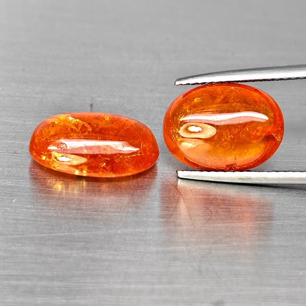 Natural Orangish Red Spessartine Garnet Gemstones 15.13 Ct. 2 Pcs. Oval Cabochon Shape and Mixed: Product ID: 802938016 Product Name: Natural Garnet Weight: 15.13 CT. Size: 14 x 10 x 5.4 to 12.9 x 9.5 x 5.5 MM. Shape: Oval Cabochon Color: Orangish Red Clarity:SI1 Luster: Good Gems Origin: Namibia 