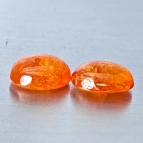 Natural Orangish Red Spessartine Garnet Gemstones 10.54 Ct. 2 Pcs. Oval Cabochon Shape 11.3 x 8.3: Product ID: 802938007 Product Name: Natural Garnet Weight: 10.54 CT. Size: 11.3 x 8.3 x 5.1 MM. Shape: Oval Cabochon Color: Orangish Red Clarity:SI1 Luster: Good Gems Origin: Namibia Treatment: Unheat