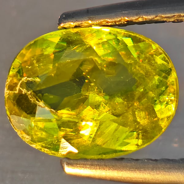 Natural Multi-Color Sphene Gemstones With Rainbow Spark 1.51 Ct. Oval Shape 8.4 x 6.5 Mm.: Product ID: 806509137 Product Name: Natural Sphene Weight: 1.51 CT. Size: 8.4 x 6.5 x 3.7 MM. Shape: Oval Shape Color: Multi-Color With Rainbow Spark Clarity:SI1 Luster: Good Gems Origin: Madagascar T