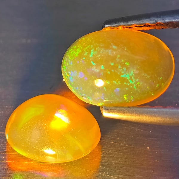 Natural Multi-Color Opal Gemstones 1.41 Ct. 2 Pcs. Oval Cabochon Shape 7.9 x 5.5 Mm.: Product ID: 818728326 Product Name: Natural Opal Weight: 1.41 CT. Size: 7.9 x 5.5 x 3.7 to 6.9 x 5.7 x 3.8 MM. Shape: Oval Cabochon Color: Multi-Color Clarity:None Luster: Good Gems Origin: Ethiopia T