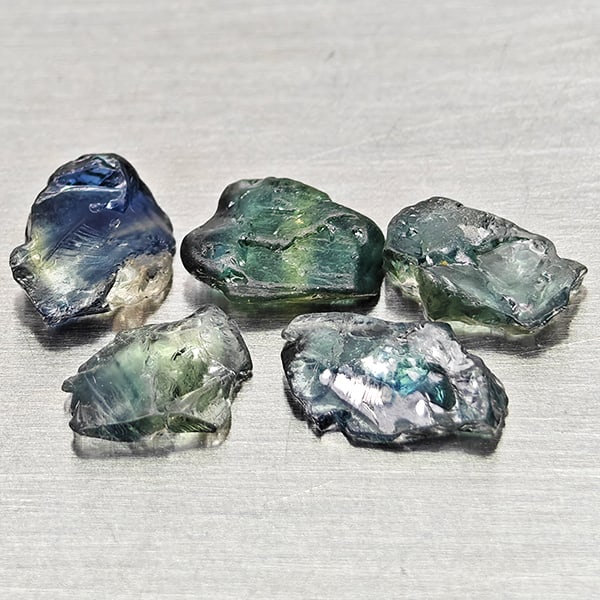 Natural Greenish Blue Sapphire Gemstones 2.58 Ct. 5 Pcs Rough Shape: Product ID: 806162525 Product Name: Natural Green Sapphire Weight: 2.58 CT. Size: 7.9 x 5.1 x 2.1 to 6.9 x 4.1 x 1.6 MM. Shape: Rough Mixed Shape Color: Greenish Blue Clarity:VSI Luster: Good Gems Ori