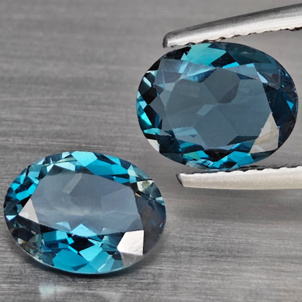Natural London Blue Topaz Gemstones 3.37 Ct. 2 Pcs. Oval Shape 9 x 7 Mm.: Product ID: 807168932 Product Name: Natural Blue Topaz Weight: 3.37 CT. Size: 9 x 7 x 3.7 MM. Shape: Oval Color: London Blue Clarity:VSI Luster: Good Gems Origin: Brazil Treatment: Treated Crystal Str