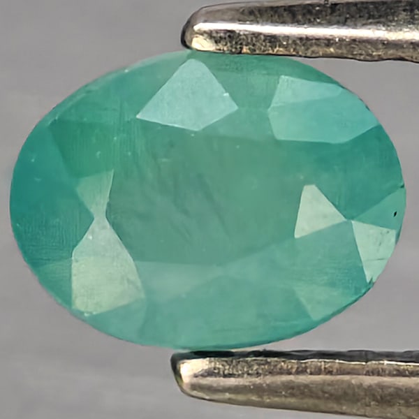 Natural Green Blueish Grandidierite Gemstones 0.94 Ct. Oval Shape 6 x 4.5 Mm.: Product ID: 803100085 Product Name: Natural Tsavorite Weight: 0.94 CT. Size: 6 x 4.5 x 4 MM. Shape: Oval Shape Color: Green Blueish Clarity:SI1 Luster: Good Gems Origin: Madagascar Treatment: Unheated