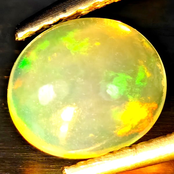 Natural Multi Color Opal Gemstones 0.92 Ct. Oval Cabochon Shape 7.4 x 6.4 Mm.: Product ID: 818728403 Product Name: Natural Opal Weight: 0.92 CT. Size: 7.4 x 6.4 x 4 MM. Shape: Oval Cabochon Color: Multi-Color Clarity:Semi - Transparent Luster: Strong Iridescent Gems Origin: Ethi