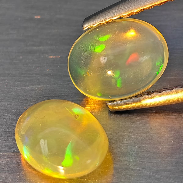 Natural Multi-Color Opal Gemstones 1.81 Ct. 2 Pcs. Oval Cabochon Shape 7.7 x 6 Mm.: Product ID: 818728318 Product Name: Natural Opal Weight: 1.81 CT. Size: 7.7 x 6 x 3.9 MM. Shape: Oval Cabochon Color: Multi-Color Clarity:None Luster: Good Gems Origin: Ethiopia Treatment: Unheated Cr