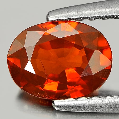 Natural Orange Red Spessartine Garnet Gemstones 0.94 Ct. Oval Shape 6.9 x 5.2 Mm.: Product ID: 802915114 Product Name: Natural Spessartine Weight: 0.94 CT. Size: 6.9 x 5.2 x 2.9 MM. Shape: Oval Color: Orange Red Clarity:VSI Luster: Good Gems Origin: Nigeria Treatment: Unheated Cryst