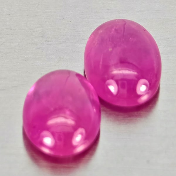 Natural Pink Red Jonson Ruby Gemstones 1.28 Ct. 2 Pcs. Oval Cabochon Shape 6.2 x 4.3 Mm.: Product ID: 805935769 Product Name: Natural Ruby Weight: 1.28 CT. Size: 6.2 x 4.3 x 2.4 MM. Shape: Oval Cabochon Color: Pink Red Clarity:Semi - Transparent Luster: Good Gems Origin: Mozambique Treatme