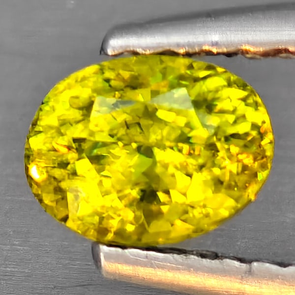 Natural Multi-Color Sphene Gemstones With Rainbow Spark 0.72 Ct. Oval Shape 5.8 x 4.5 Mm.: Product ID: 806509307 Product Name: Natural Sphene Weight: 0.72 CT. Size: 5.8 x 4.5 x 3.7 MM. Shape: Oval Color: Multi-Color Clarity:SI1 Luster: Good Gems Origin: Madagascar Treatment: Unheated Crysta
