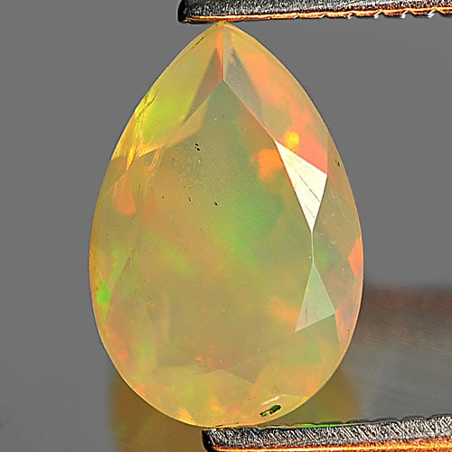 Natural Multi Color Play Of Colour Opal Gemstones 0.76 Ct. Pear Shape 8.9 x 6 Mm.: Product ID: 818726064 Product Name: Natural Opal Weight: 0.76 CT. Size: 8.9 x 6 x 4.1 MM. Shape: Pear Color: Multi Color Clarity:Semi - Transparent Luster: Iridescent Gems Origin: Ethiopia Treatment: 