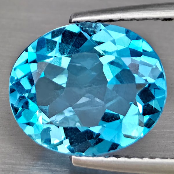 Natural Swiss Blue Topaz Gemstones 4.96 Ct. Oval Shape 12 x 10 Mm.: Product ID: 807169011 Product Name: Natural Blue Topaz Weight: 4.96 CT. Size: 12 x 10 x 5.7 MM. Shape: Oval Shape Color: Swiss Blue Clarity:VSI Luster: Good Gems Origin: Brazil Treatment: Treated Crys