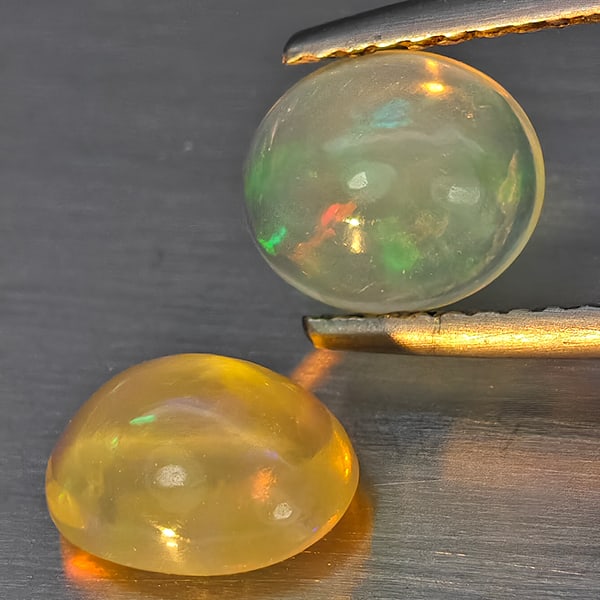 Natural Multi Color Play Of Colour Opal Gemstones 1.62 Ct. 2 Pcs. Oval Cabochon Shape 7.8 x 6.3 Mm.: Product ID: 818728369 Product Name: Natural Opal Weight: 1.62 CT. Size: 7.8 x 6.3 x 4.1 MM. Shape: Oval Cabochon Color: Multi-Color Clarity:None Luster: Good Gems Origin: Ethiopia Treatment: Unheated 