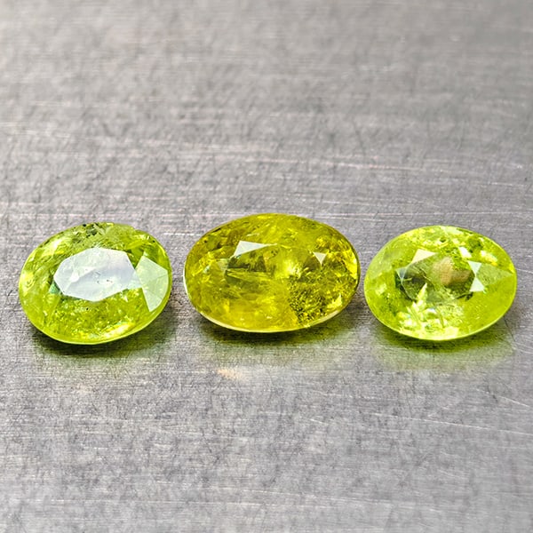 Natural Sphene Intense Green Titanium Red Spark 1.68 Ct. 3 Pcs.Oval Shape: Product ID: 806509007 Product Name: Natural Sphene Weight: 1.68 CT. Size: 6.3 x 4.3 x 3.1 to 5.4 x 4.2 x 2.6 MM. Shape: Oval Color: Intense Yellow Green With Red Spark Clarity:SI Luster: Good Gems Ori