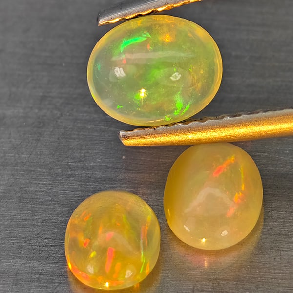 Natural Multi-Color Play Of Colour Opal Gemstones 1.62 Ct. 3 Pcs. Oval Cabochon Shape 6.8 x 5 Mm.: Product ID: 818728304 Product Name: Natural Opal Weight: 1.62 CT. Size: 6.8 x 5 x 3.5 MM. Shape: Oval Cabochon Color: Multi-Color Clarity:None Luster: Good Gems Origin: Ethiopia Treatment: Unheated Cr