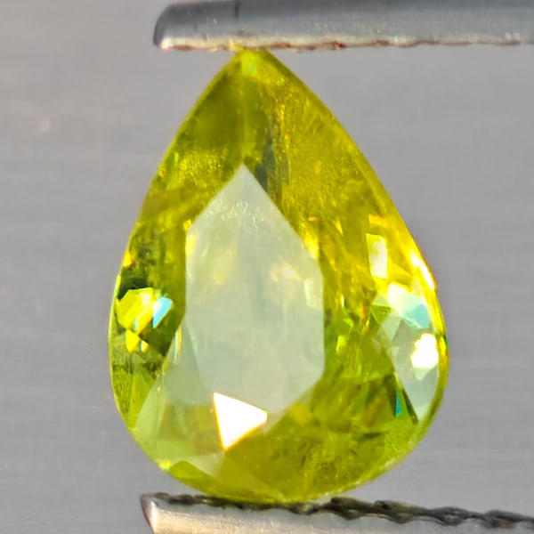 Natural Multi-Color Sphene Gemstones With Rainbow Spark 1.17 Ct. Pear Shape 8.2 x 6.2 Mm.: Product ID: 806509169 Product Name: Natural Sphene Weight: 1.17 CT. Size: 8.1 x 6.2 x 3.4 MM. Shape: Pear Shape Color: Multi-Color With Rainbow Spark Clarity:SI1 Luster: Good Gems Origin: Madagascar T
