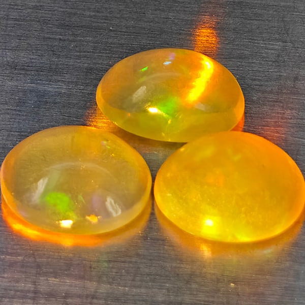 Natural Multi-Color Opal 0.90 Ct. 2 Pcs. Oval Cabochon Shape 6.7 x 4.3 Mm.: Product ID: 818728303 Product Name: Natural Opal Weight: 0.90 CT. Size: 6.7 x 4.3 x 3.3 MM. Shape: Oval Cabochon Color: Multi-Color Clarity:None Luster: Good Gems Origin: Ethiopia Treatment: Unheated 