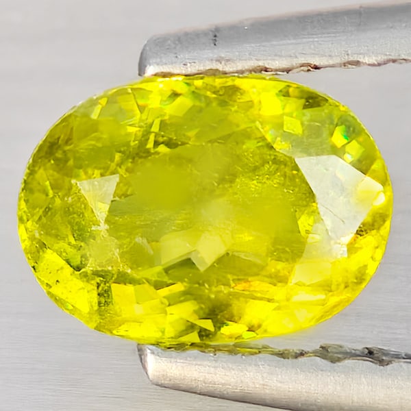 Natural Multi-Color Sphene Gemstones With Rainbow Spark 1.03 Ct. Oval Shape 6.9 x 5.1 Mm.: Product ID: 806509158 Product Name: Natural Sphene Weight: 1.03 CT. Size: 6.9 x 5.1 x 3.6 MM. Shape: Oval Shape Color: Multi-Color With Rainbow Spark Clarity:SI1 Luster: Good Gems Origin: Madagascar T