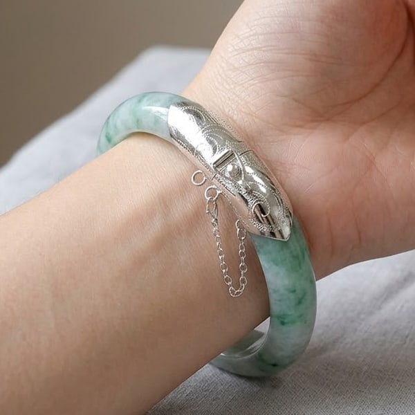 Natural Multi-Color Jade Gemstones Bangle 325 Ct. with Silver Diameter 65 Mm.: Product ID: 819814077 Product Name: Natural Jade Weight: 325.00 CT. Size: 80 x 65 x 13 MM. Shape: Round Cabochon Color: Multi-Color Clarity:Opaque Luster: Good Gems Origin: Thailand Treatment: Unheate