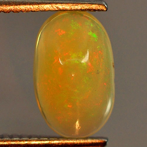 Natural Play Of Colour Multi Color Opal Gemstones 0.62 Ct. Oval Cabochon Shape 8.3 x 5 Mm.: Product ID: 818725987 Product Name: Natural Opal Weight: 0.62 CT. Size: 8.3 x 5 x 3.6 MM. Shape: Oval Cabochon Color: Multi Color Clarity:Opaque Luster: Iridescent Gems Origin: Ethiopia Treatment: Unh