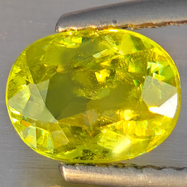 Natural Multi-Color With Rainbow Spark Sphene Gemstones 1.31 Ct. Oval Shape 7.8 x 5.9 Mm.: Product ID: 806509160 Product Name: Natural Sphene Weight: 1.31 CT. Size: 7.8 x 5.9 x 3.7 MM. Shape: Oval Shape Color: Multi-Color With Rainbow Spark Clarity:SI1 Luster: Good Gems Origin: Madagascar T