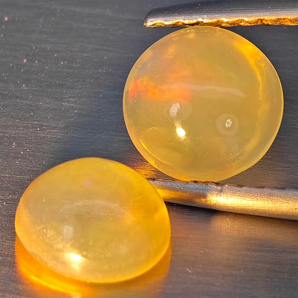 Natural Multi-Color Opal Gemstones 1.34 Ct. 2 Pcs. Oval Cabochon Shape 6.7 x 6 Mm.: Product ID: 818728324 Product Name: Natural Opal Weight: 1.34 CT. Size: 6.7 x 6 x 3.6 MM. Shape: Oval Cabochon Color: Multi-Color Clarity:None Luster: Good Gems Origin: Ethiopia Treatment: Unheated Cr
