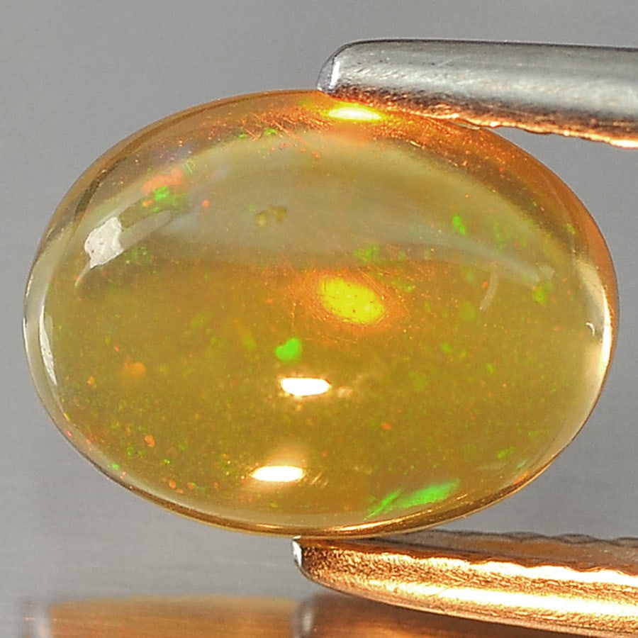 Natural Play Of Multi Color Opal Gemstones 1.18 Ct. Oval Cabochon Shape 9.1 x 7 Mm.: Product ID: 818726977 Product Name: Natural Opal Weight: 1.18 CT. Size: 9.1 x 7 x 3.4 MM. Shape: Oval Cabochon Color: Multi Color Clarity:Semi - Transparent Luster: Iridescent Gems Origin: Ethiopia Tr