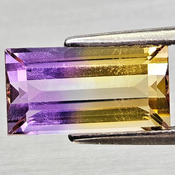 Natural Bi Color Ametrine Gemstones 2.54 Ct. Baguette Shape 11 x 6 Mm.: Product ID: 800408254 Product Name: Natural Ametrine Weight: 2.54 CT. Size: 11 x 6 x 4.9 MM. Shape: Baguette Color: Bi Color Clarity:VSI Luster: Good Gems Origin: Bolivia Treatment: Unheated Crystal S