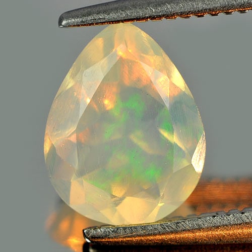 Natural Multi Color Play Of Colour Opal Gemstones 0.79 Ct. Pear Shape 8.6 x 8.6 Mm.: Product ID: 818726161 Product Name: Natural Opal Weight: 0.79 CT. Size: 8.6 x 6.8 x 4.1 MM. Shape: Pear Color: Multi Color Clarity:Semi - Transparent Luster: Iridescent Gems Origin: Ethiopia Treatment