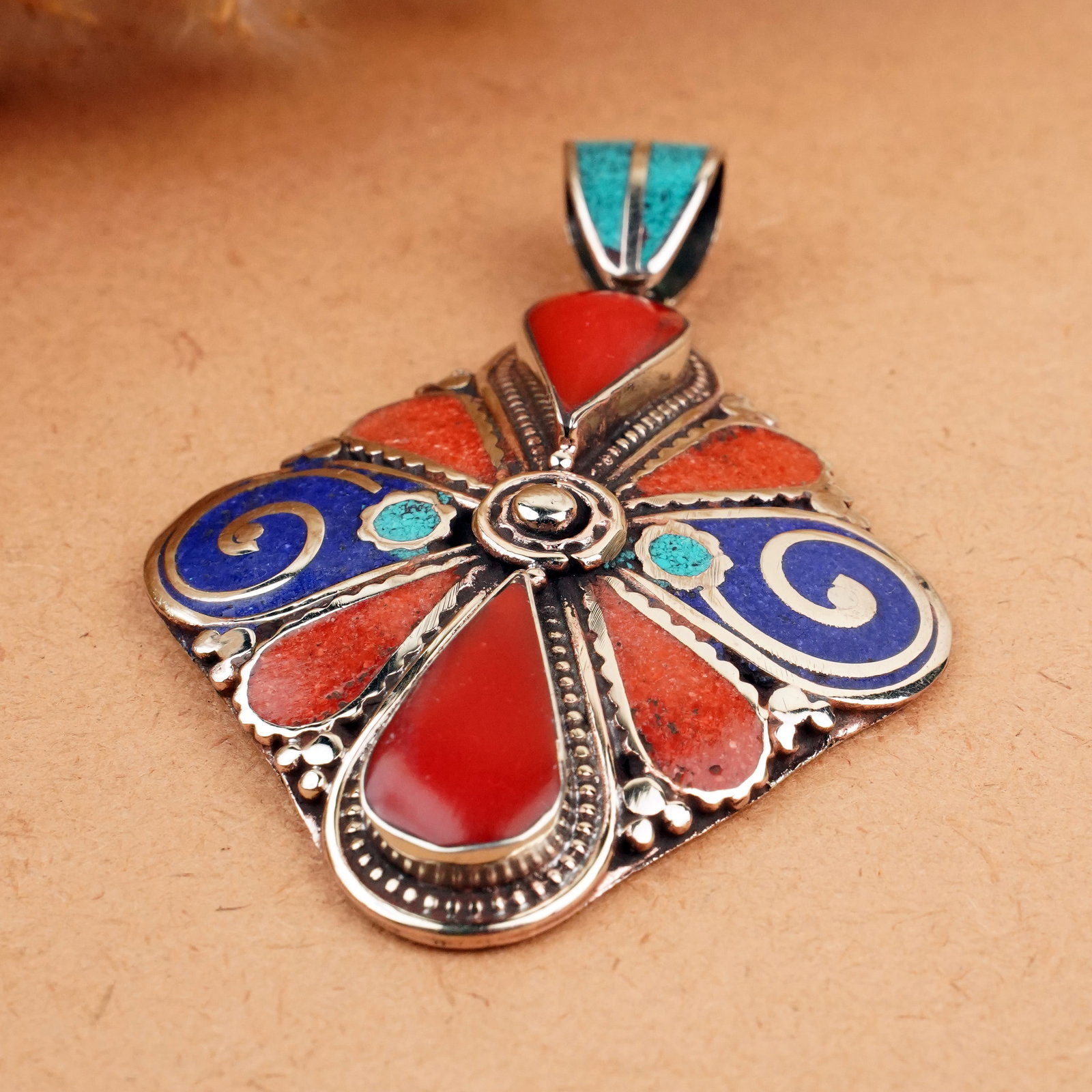 Tibetan Turquoise, Coral & Lapis Handmade Ethnic Pendant: Product ID: 260407150117 Product - Tibetan Natural Handmade Pendant Gemstone - Natural Turquoise & Coral & Lapis Pendant Size - 6X5 CM Pendant Weight - 25 Gram Metal - Brass & Copper mix Metal Origin 