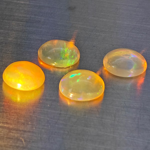Natural Multi-Color Play Of Colour Opal Gemstones 2.60 Ct. 5 Pcs. Oval Cabochon Shape 6.8 x 5.6 Mm.: Product ID: 818728331 Product Name: Natural Opal Weight: 2.60 CT. Size: 6.8 x 5.6 x 3.4 MM. Shape: Oval Cabochon Color: Multi-Color Clarity:None Luster: Good Gems Origin: Ethiopia Treatment: Unheated 