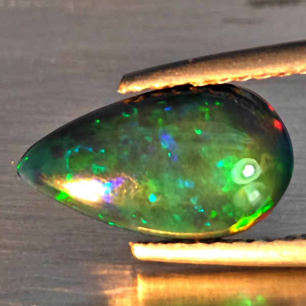 Natural Multi Color Opal Gemstones 1.83 Ct. Pear Cabochon Shape 11.8 x 7.9 Mm.: Product ID: 818728535 Product Name: Natural Opal Weight: 1.83 CT. Size: 11.8 x 7.9 x 4.4 MM. Shape: Pear Cabochon Color: Multi-Color Clarity:Semi - Transparent Luster: Good Gems Origin: Ethiopia Treat