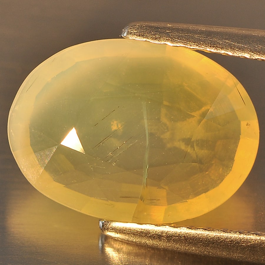 Natural Yellow Color Opal Gemstones 2.02 Ct. Oval Shape 12.2 x 8.9 Mm.: Product ID: 818712176 Product Name: Natural Opal Weight: 2.02 CT. Size: 12.2 x 8.9 x 4.2 MM. Shape: Oval Color: Yellow Clarity:Semi - Transparent Luster: Good Gems Origin: Ethiopia Treatment: Unheated