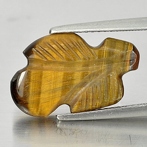 Natural Golden Tiger Eye 5.40 Ct. Leaves Carving Shape 18.6 x 10.3 Mm.: Product ID: 811600037 Product Name: Natural Tiger eye Weight: 5.40 CT. Size: 18.6 x 10.3 x 3.4 MM. Shape: Carving Leaves Color: Golden Clarity:Opaque Luster: Good Gems Origin: Thailand Treatment: Unhe
